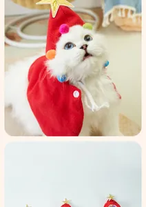 Close-up detail of a festive red pet Christmas cape featuring colorful pom-poms