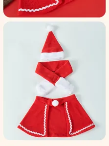 Detail view of 3-piece Christmas pet costume set with Santa hat, scarf, and red fleece cape.