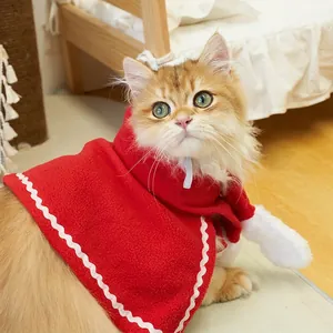 Festive red Christmas cape for cats with white wavy trim decor for holiday atmosphere