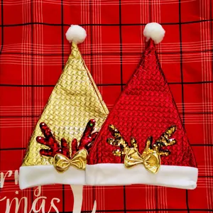 Close-up of festive sequin reindeer antler Christmas hats in red and gold finish