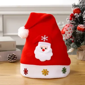 Detail view of red plush Santa hat with Santa Claus appliqué and colorful sequins.