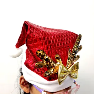 Shiny red Christmas hat featuring sequined reindeer antlers and a golden bow detail.