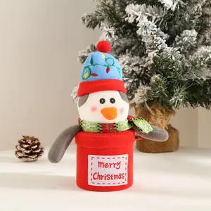 Detailed view of plush penguin Christmas gift bucket with Merry Christmas embroidery