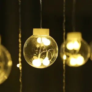 Close-up of warm LED wish ball decorative curtain light with bokeh background and cozy atmosphere