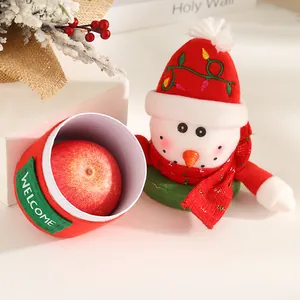 Detailed view of a Christmas snowman plush gift bucket holding a decorative red apple inside