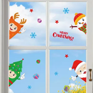 Detail of Christmas window stickers featuring Santa, snowman, and reindeer on a glass