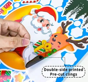 Detail of double-sided printed Santa and reindeer Christmas window clings being peeled off.