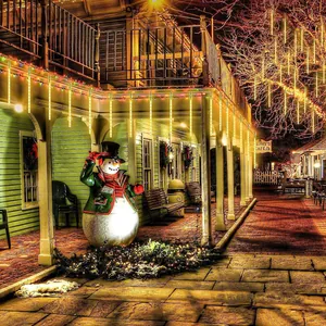 Meteor shower lights hanging from eaves in a cozy Christmas courtyard