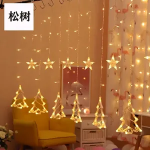 Detail of warm white LED curtain lights with glowing star and pine tree shapes