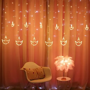 Warm white Diya-shaped LED curtain string lights hanging over translucent curtains