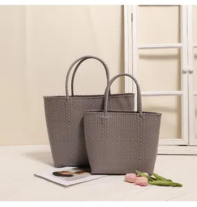 Detail view of woven plastic tote bags in two sizes for beach or shopping