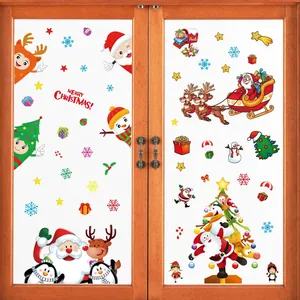 Festive Christmas window stickers featuring Santa Claus, reindeer, and snowflakes on a glass door.