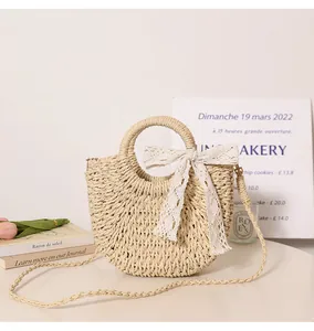 Woven straw handbag with lace bow detail and round handle for summer