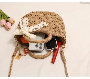 Macro view of straw woven bag with lace bow showing interior item storage capacity