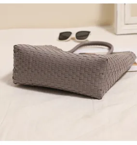Detailed close-up showing the grey woven pattern of the plastic beach basket handbag