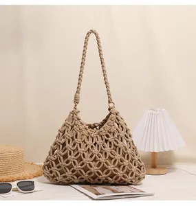 Handmade macramé woven shoulder bag for beach vacations featuring a cream inner lining