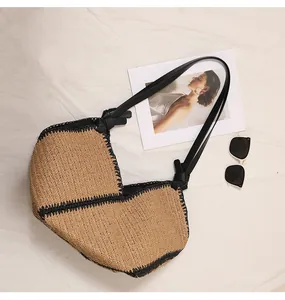Detailed top view of a French style straw woven tote bag with black trim and handles