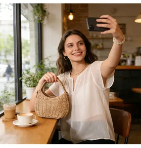 Lifestyle shot of a woman with a small woven straw beach bag in a cafe setting