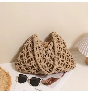 Detailed macro view of a beige woven cotton rope beach bag with vacation props