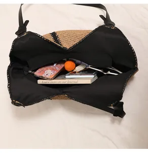 Detailed view of woven straw bag interior with black lining and ample storage space.