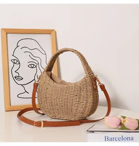 Close-up detail of hand-woven straw bag with leather strap in a minimalist decor setting