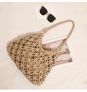 Detail view of a handmade woven cotton beach bag with stylish hollow design and lining