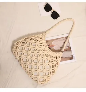 Detailed view of cream cotton rope woven shoulder bag with intricate knot patterns.