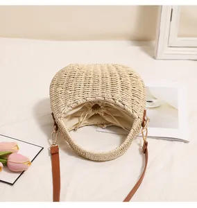 Interior detail of hand-woven straw beach bag featuring a secure beige drawstring lining