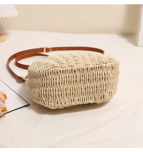 Close-up of fine hand-woven texture on cream straw beach bag for summer vacation