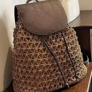 Handcrafted straw woven backpack with brown leather flap and drawstring for beach travel