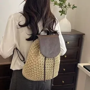 Handmade hollow straw backpack with brown leather flap and drawstring closure for women