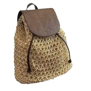 Hand-woven straw backpack featuring a brown faux-leather flap and drawstring closure for beach.