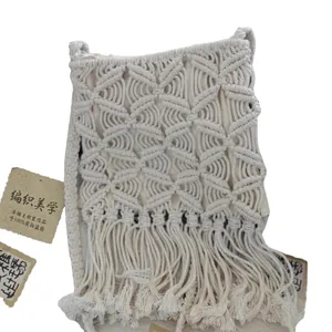 Bohemian macramé cotton woven shoulder bag with decorative fringes for beach.