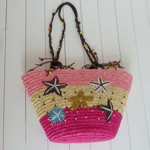 Handmade summer straw beach bag featuring colorful star decorations and beaded woven straps
