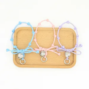 Braided bow phone wrist strap with metallic heart charm in multiple pastel colors set