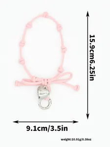 Detailed view of pink bow braided phone wrist strap with dimensions and weight