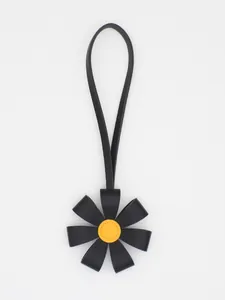 Premium 3D PU leather flower bag charm featuring black petals and yellow center