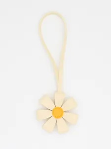 Detail of a white and yellow PU leather 3D flower bag charm with long strap