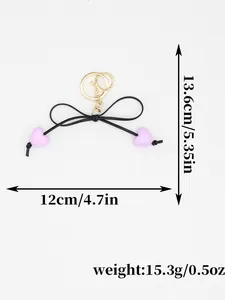 Close-up of heart bow keychain with dimensions 12x13.6cm and weight 15.3g details