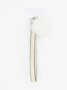 Detail view of a white PU leather wrist strap keychain with a fluffy fur ball charm