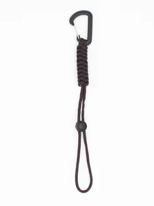 Detailed view of dark brown paracord tactical keychain with carabiner hook for camping