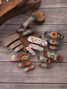 Detailed macro view of retro western-style hair clips with sunflower and cowboy patterns