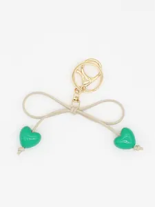 Cute macaron green heart and beige bow keychain bag charm featuring elegant gold lobster clasp