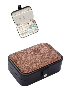 Western style embossed jewelry box showing exterior floral pattern and interior storage
