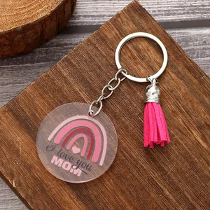 Close-up view of acrylic keychain with pink tassel and I love you MOM rainbow design