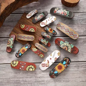 Detailed view of vintage western style hair clips with sunflower and cow patterns