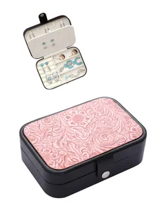 Vintage Western-style embossed jewelry box featuring a floral design and internal storage
