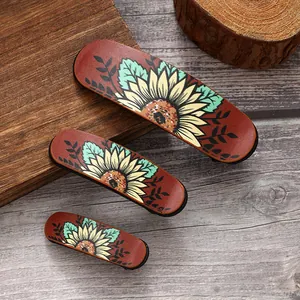 Close-up detail of retro sunflower pattern hair clip set on wooden background