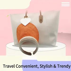 Detail of a white heart-shaped PU magnetic hat clip attached to a tote bag