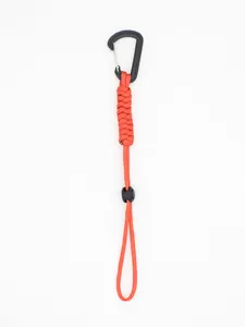 Close-up detail of a bright red braided paracord lanyard with a black tactical carabiner